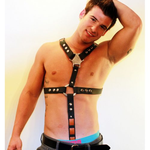 A Man Smiling WIth Hand Raising Wearing a Black Color Leather Harness