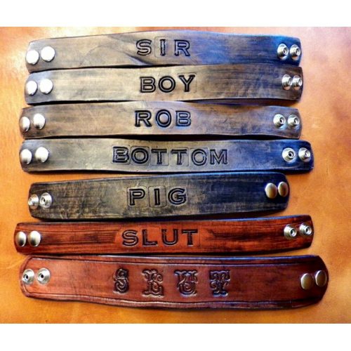 A Line of Leather Bands With Button Adjustment