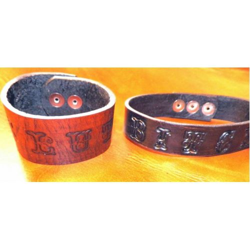 Two Leather Bands With Design Carved WIth Buttons